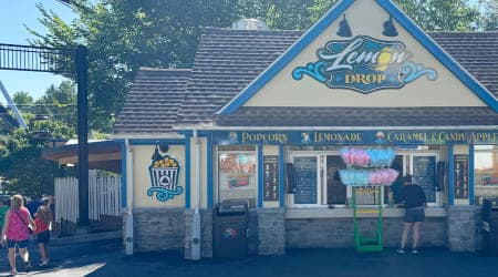Yellow painted Lemon Drop building with order window and signage on the building.