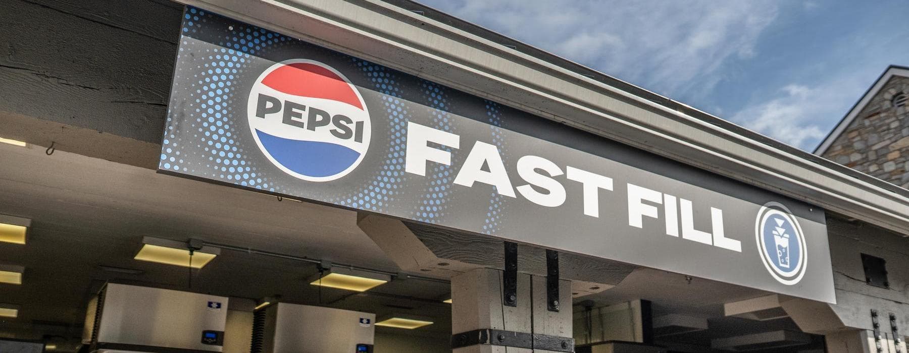 Inside of building with Pepsi machines and queue line