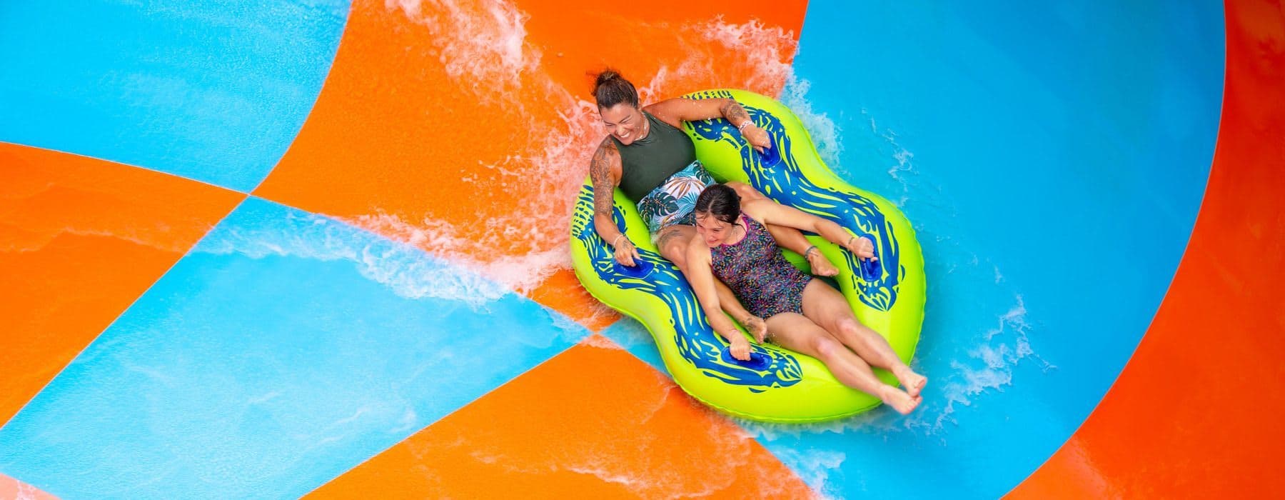 Girls riding Coastline Plunge Vortex water slide