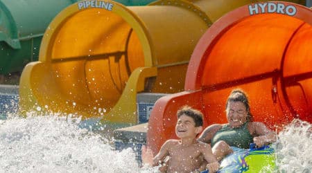 Boy and Mom coming out of the bottom of coastline plunge hydro water slide