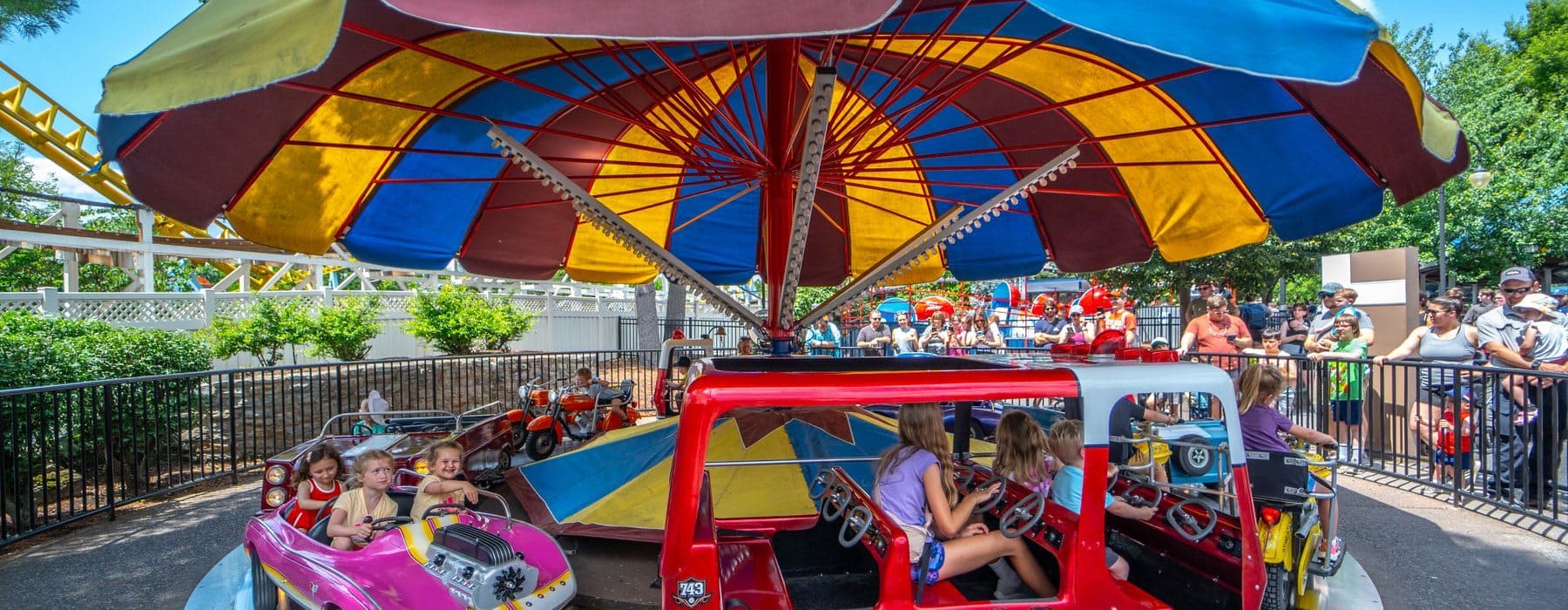 Children Smiling on Traffic Jam ride at Hersheypark as they pretend to drive a car