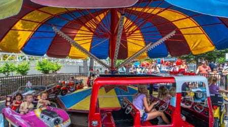 Children Smiling on Traffic Jam ride at Hersheypark as they pretend to drive a car