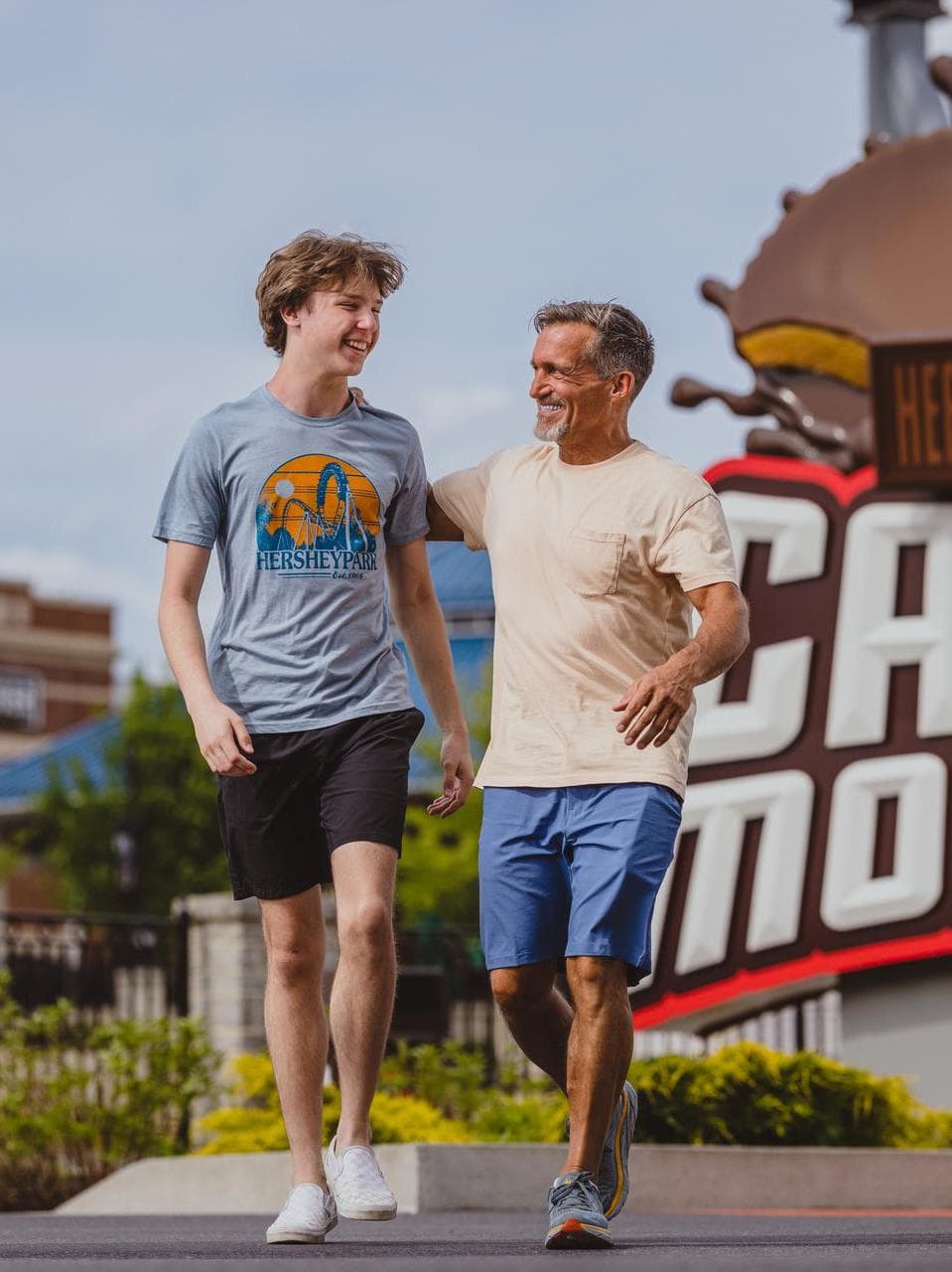father_son_walking_candmonium_sign.jpg